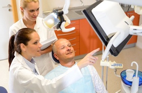 Male patient learning about his tooth replacement options