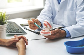 Dentist and patient discussing tooth replacement options during consultation