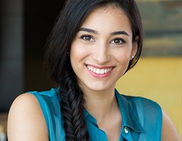 Smiling young woman wearing blue blouse