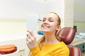 happy dental patient with mirror