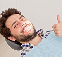 Male dental patient making thumbs up gesture