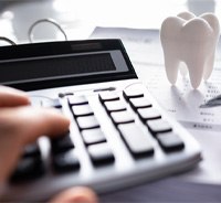Using calculator to budget for dental care