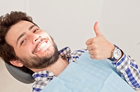 dental patient giving thumbs up