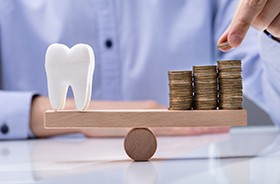 Tooth model and coins balanced on scale