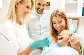 Parents and daughter receiving family dentistry in Auburn