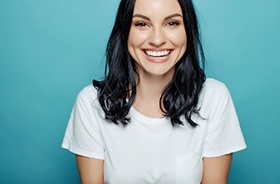 Smiling young woman enjoying benefits of tooth-colored fillings