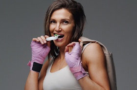 Fit woman using mouthguard to protect teeth during sports