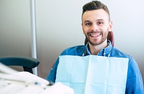 Happy man at appointment with his implant dentist