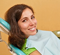 Happy dental patient at appointment for preliminary dental implant treatment