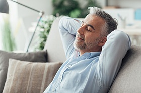 Man resting at home after dental implant surgery