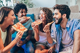 Group of friends eating pizza