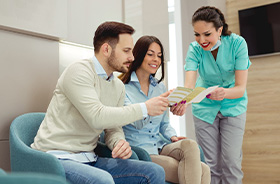 Couple learning about options for paying for Invisalign