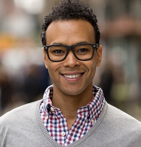 Smiling man wearing gray cardigan