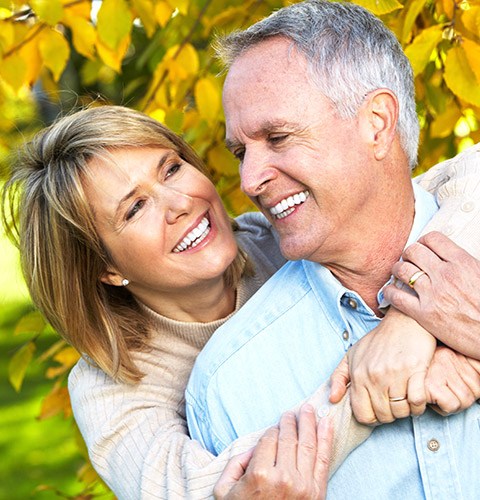 Smiling older man and woman outdoors