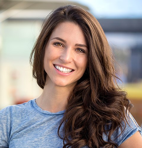 Smiling young woman wearing blue blouse