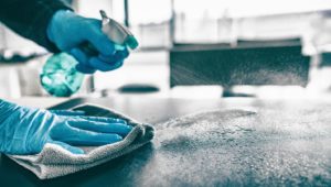 disinfecting countertop as part of dental safety protocol