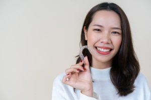 Smiling woman, fixing TMJ with Invisalign in Auburn
