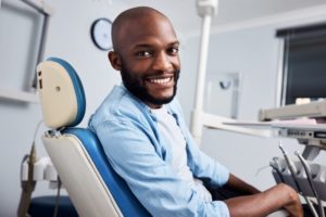 Smiling male dental patient looking over his shoulder