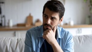 Concerned man touching his chin