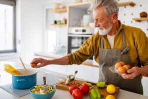 Senior man cooking tasty food