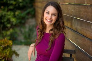 Woman with a beautiful smile sitting outdoors 